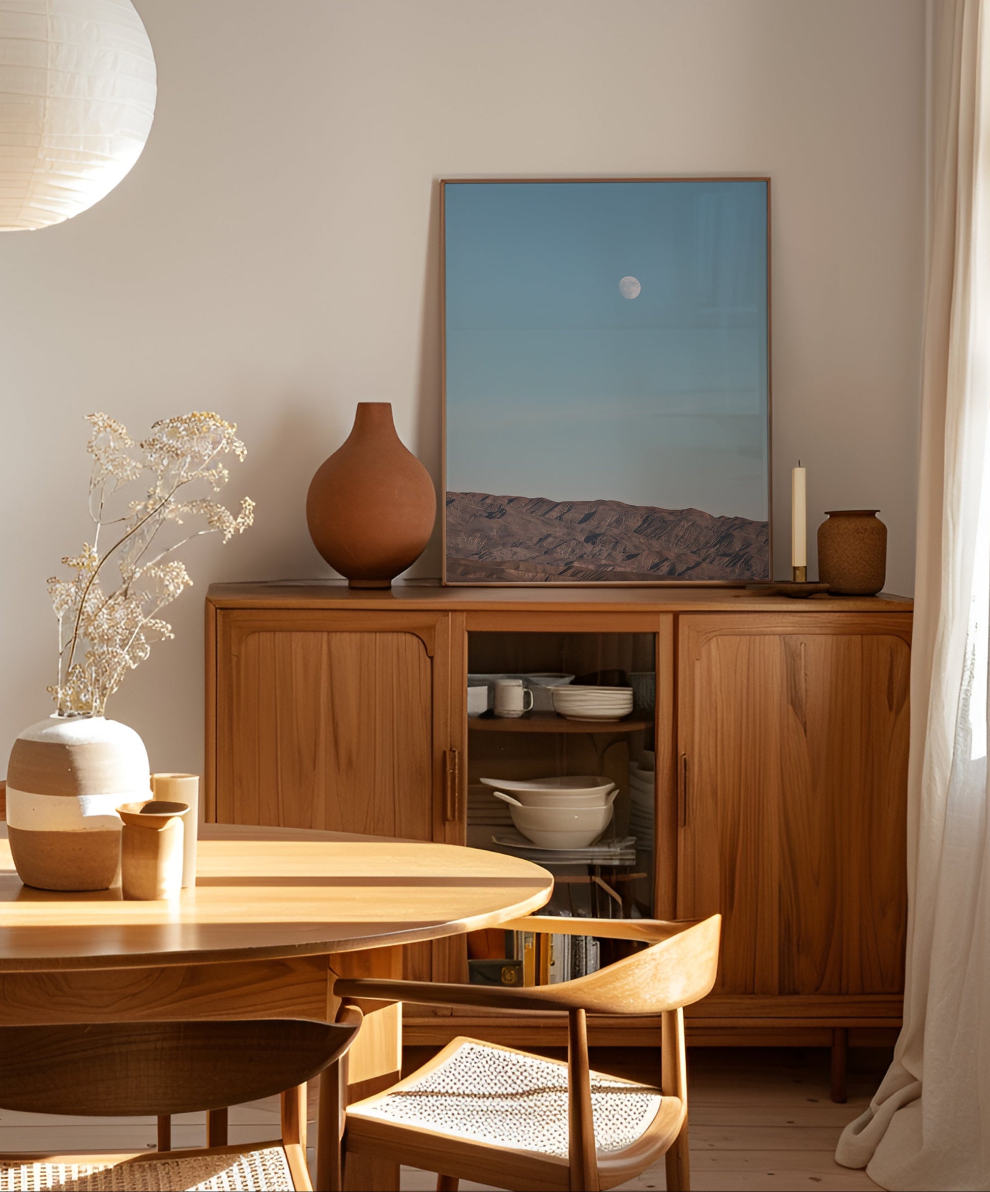 RiSiNG: serene desert landscape with moon rising over mountains in soft blue sky, perfect for calming interiors.