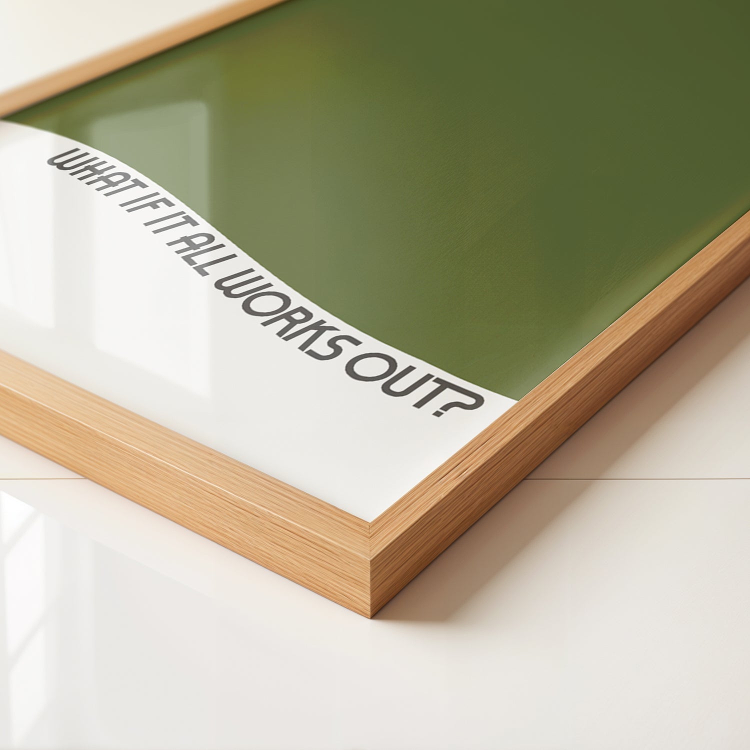 Framed minimalist poster titled WHAT iF iT ALL WORKS OUT with olive green and wavy text on matte paper.
