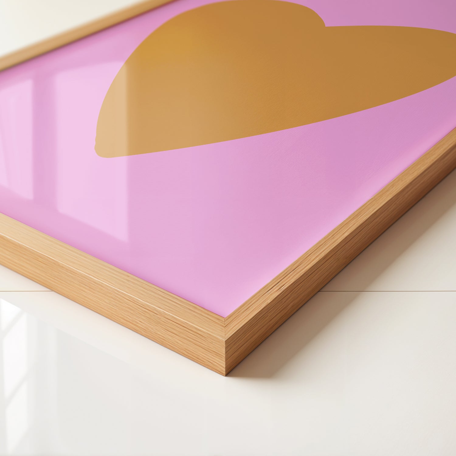 Close-up of HEART of GOLD poster featuring a gold heart on vibrant pink background in a wooden frame.