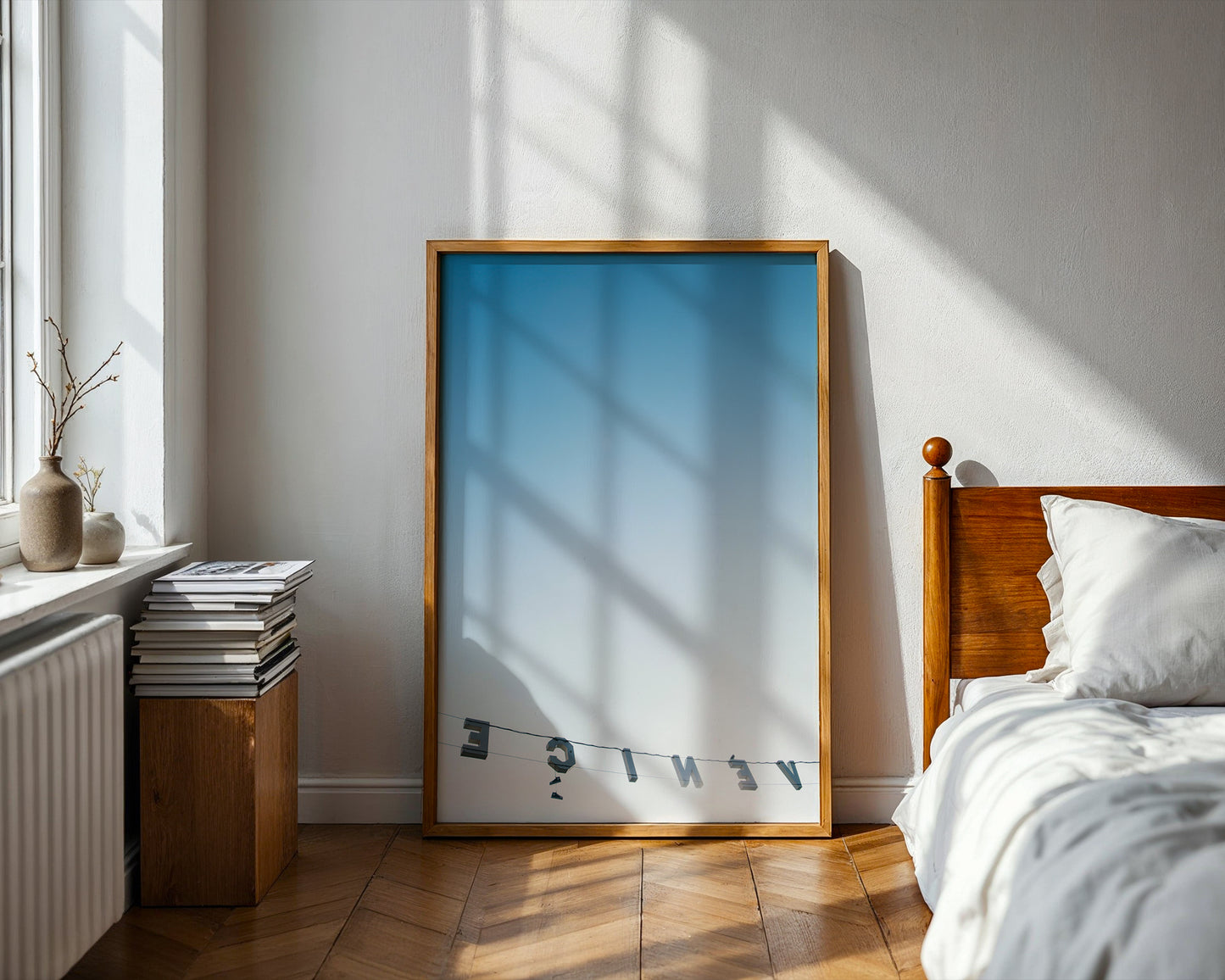 BACKWARDS features a reversed Venice sign against a soft blue ombré sky in a sunlit, minimalist bedroom setting.