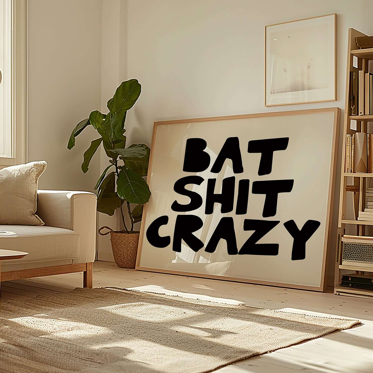 BAT SHiT CRAZY poster with bold black hand-lettered typography in a bright, modern living room setting.