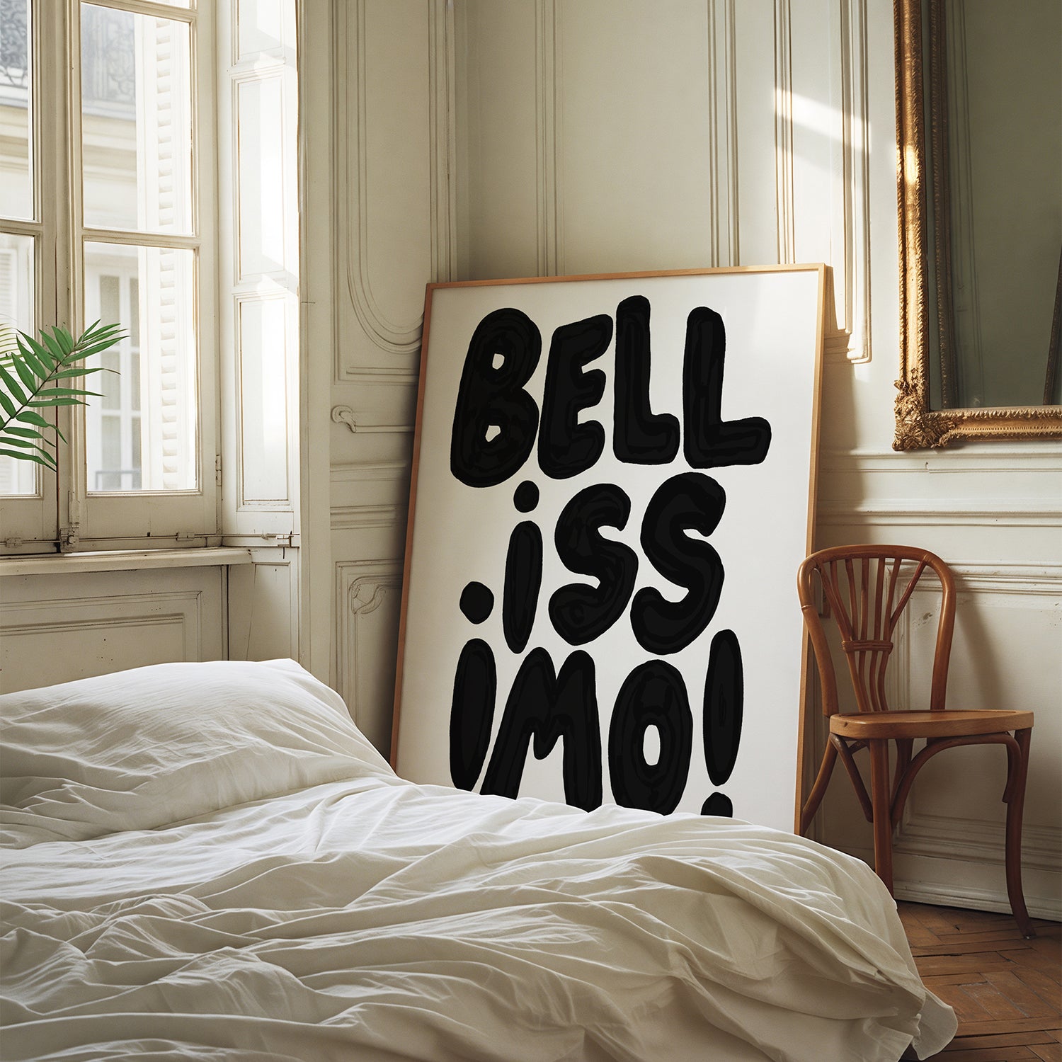 BELLiSSiMO! black & white poster with bold hand-lettered typography leaning against wall in cozy bedroom corner.