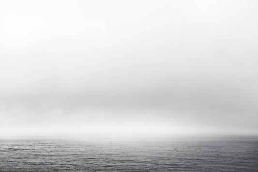 Black and white ocean view with fog and gentle waves – minimalist seascape photography