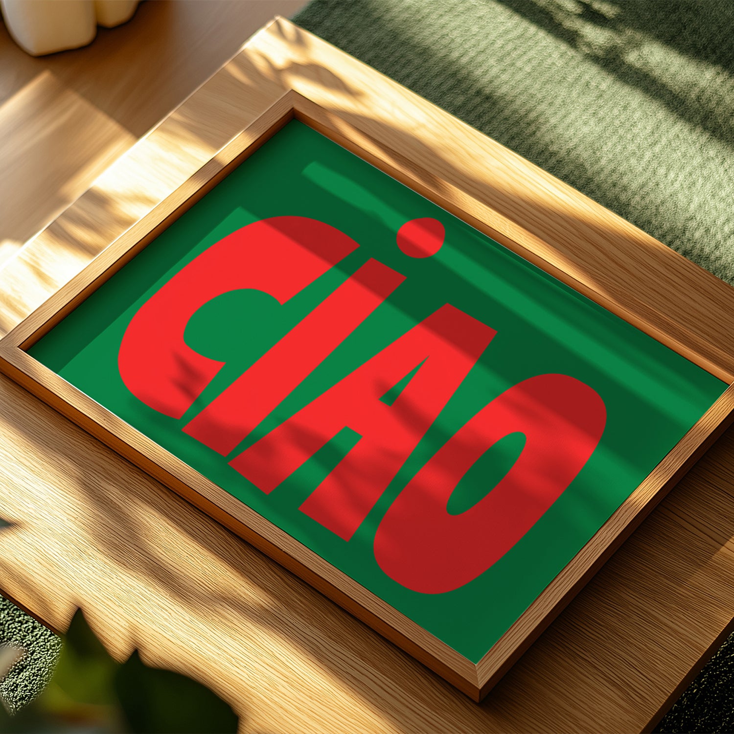 CiAO / RED on GREEN poster with bold red letters on green background in a minimalist wooden frame.