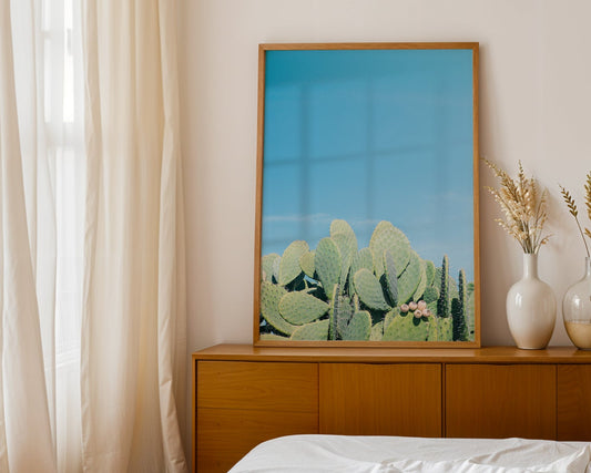 DAYDREAM artwork featuring prickly pear cacti under a clear blue sky in a modern Southwest minimalist interior.