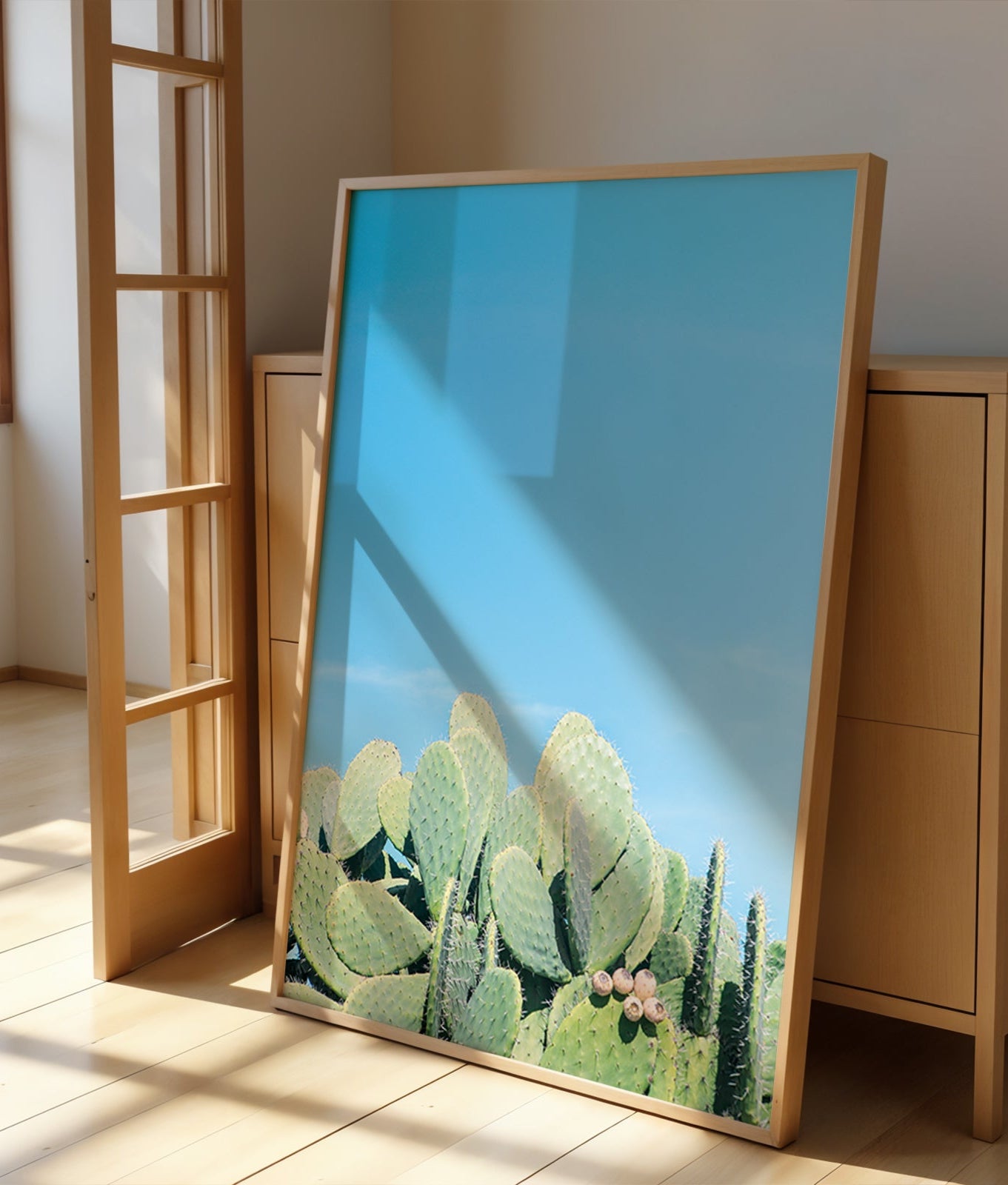 DAYDREAM art print featuring sunlit prickly pear cacti under a clear blue sky in a modern wooden frame