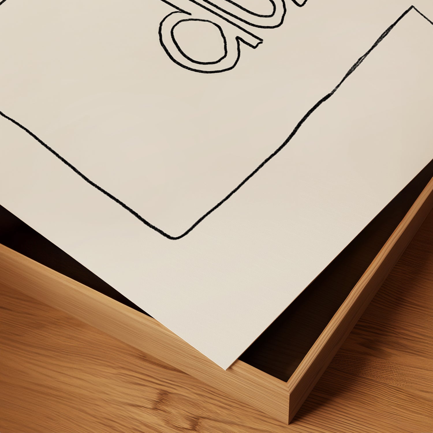 Close-up of "DUH" minimalist poster with hand-drawn text on matte paper corner resting in wooden frame.