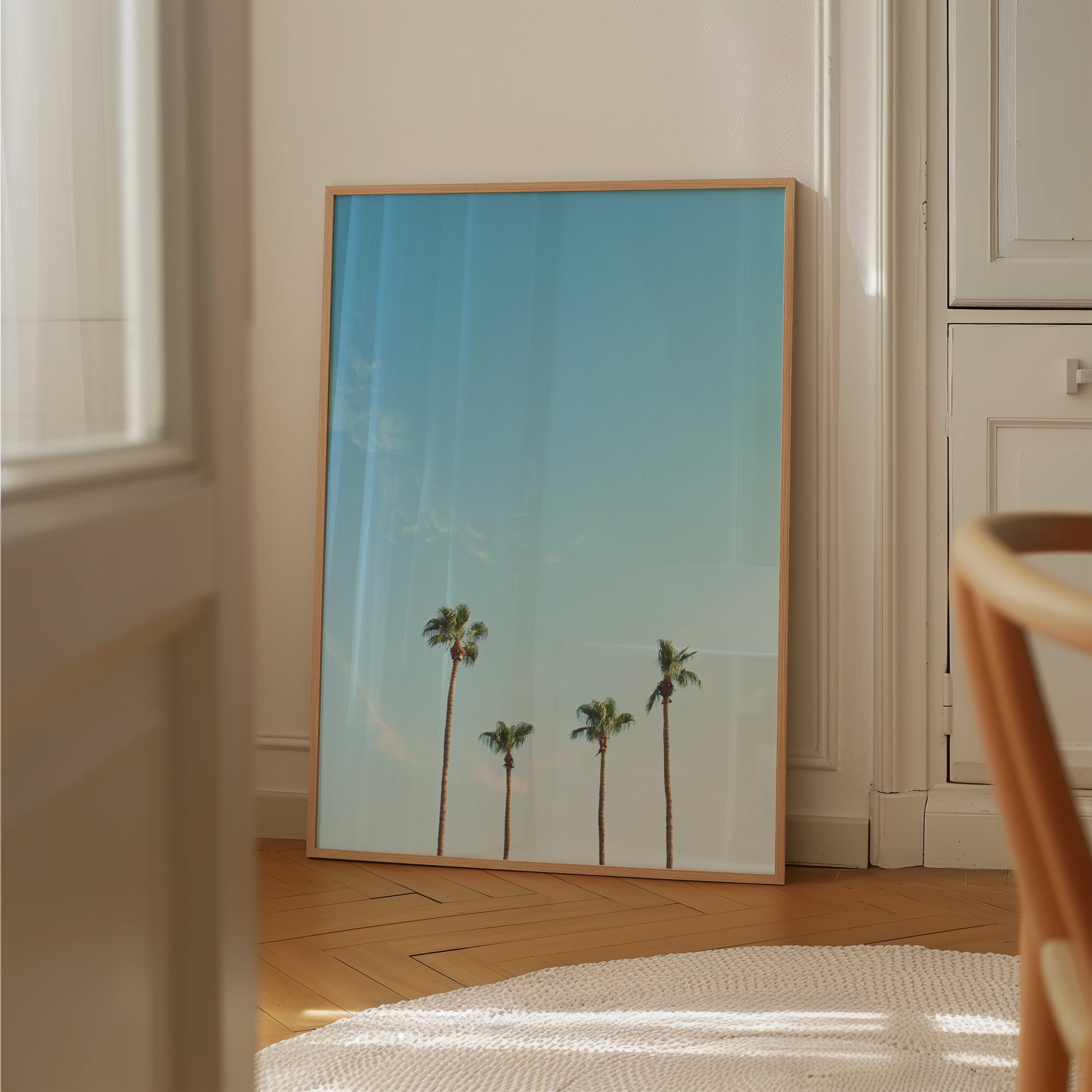 Framed minimalist palm tree print titled FAMiLiA with blue sky, perfect for modern, coastal, and boho decor.