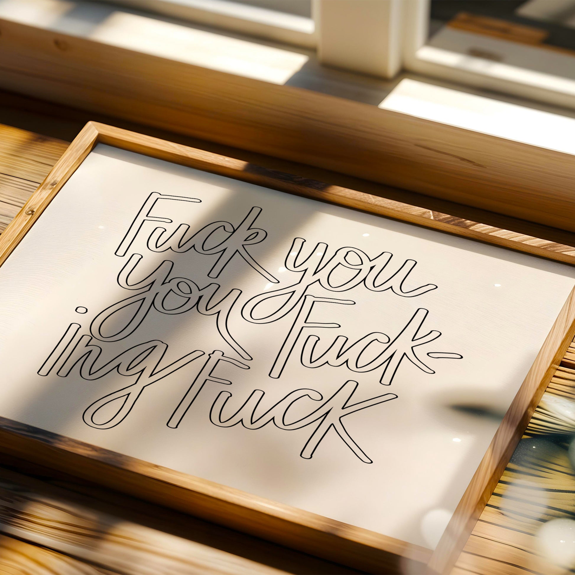 Hand-lettered black and white poster reading "FUCK YOU YOU FUCKING FUCK" titled FUCK YOU YOU FUCKING FUCK in wooden frame.