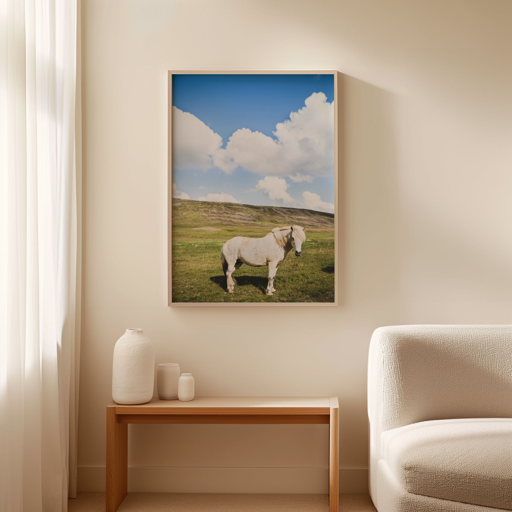 Hi HENRiETTA featuring a white Icelandic horse in a peaceful field under a bright blue sky with clouds.