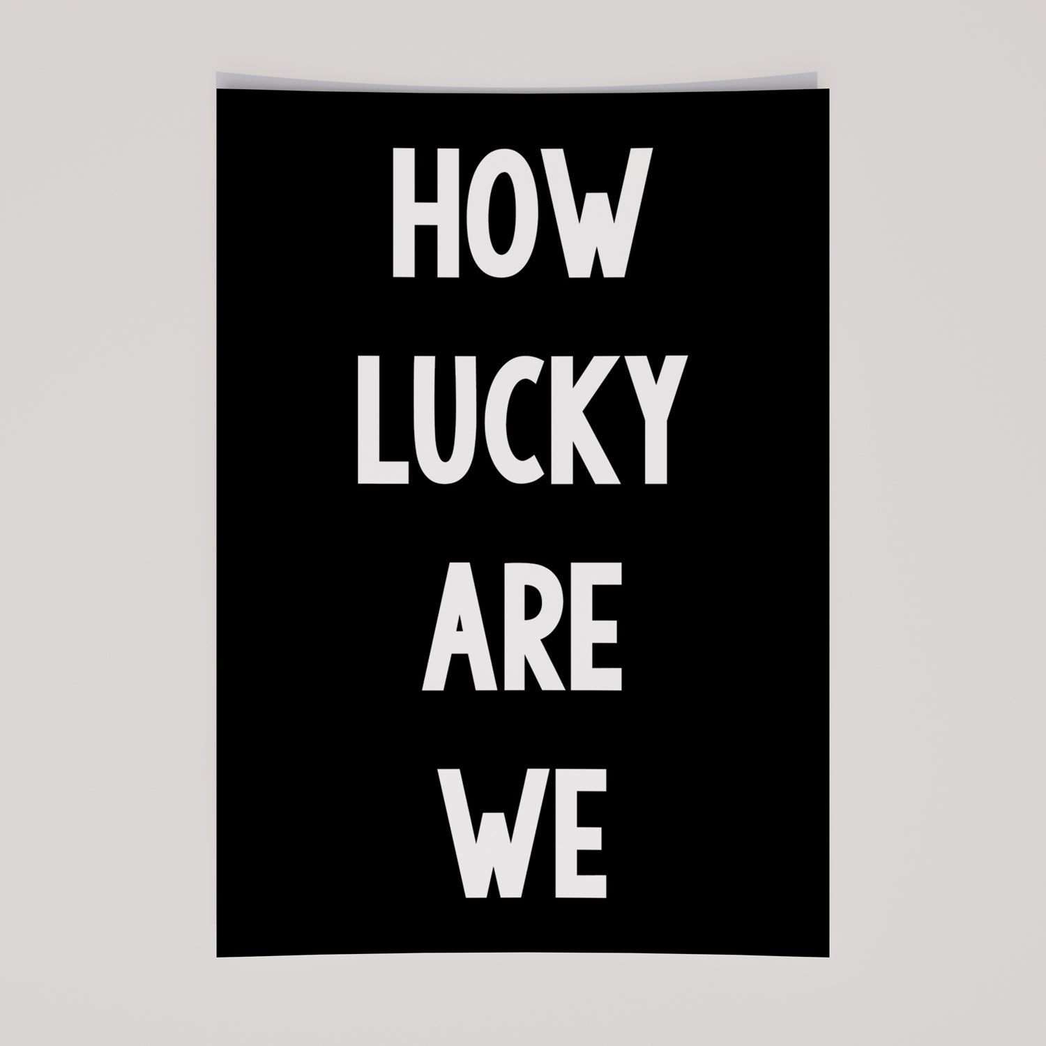 Black-and-white poster with bold white typography reading HOW LUCKY ARE WE, minimalist modern affirmation print.