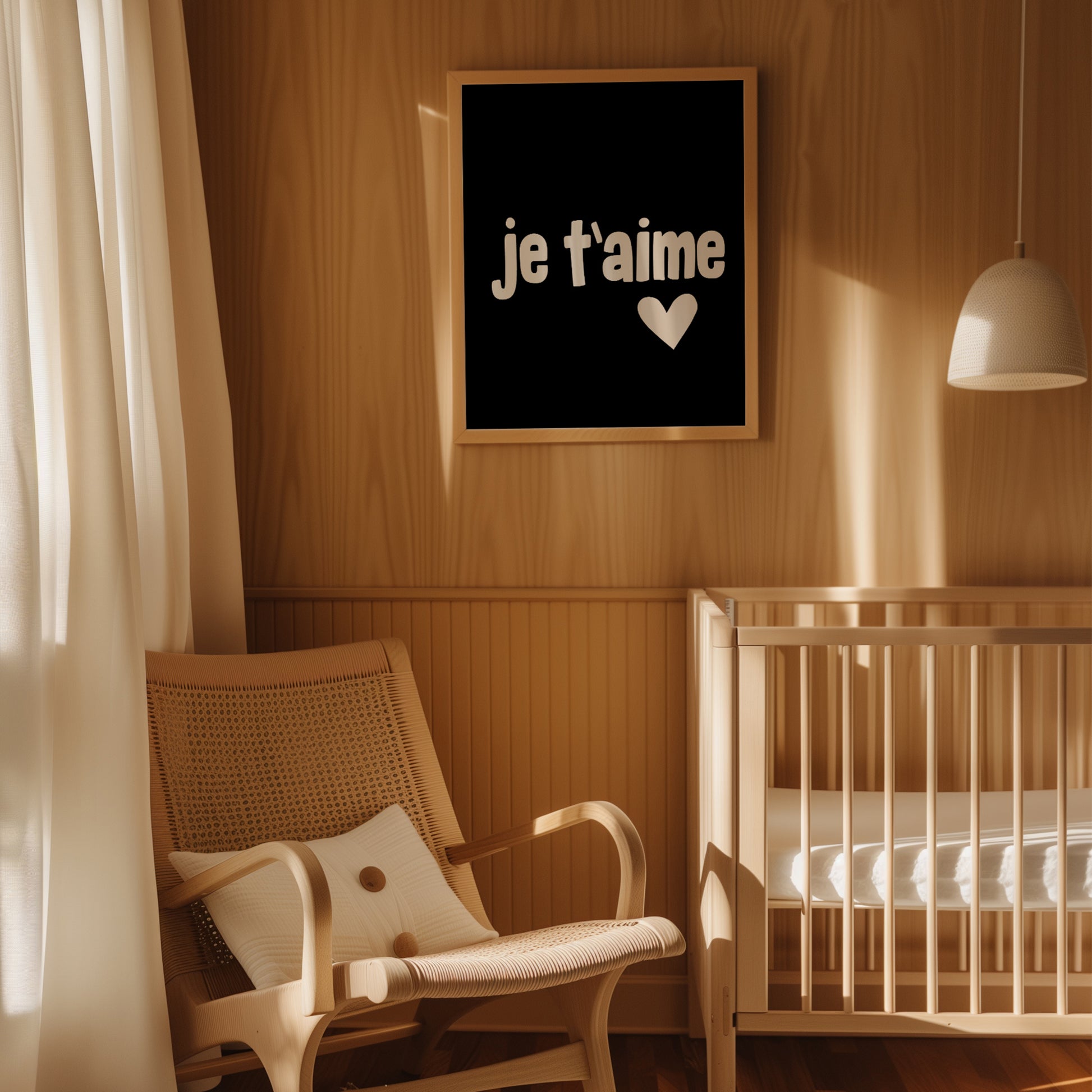 JE T'AiME poster with black-and-white print and heart detail in a cozy nursery setting.