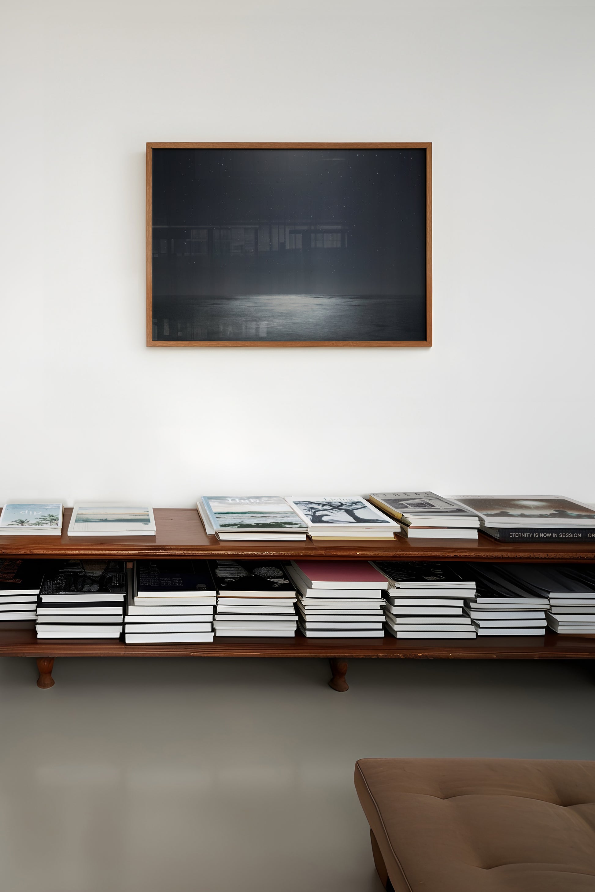 MiDNiGHT serene starry night sky over moonlit sea photograph in shades of black and grey framed on wall.