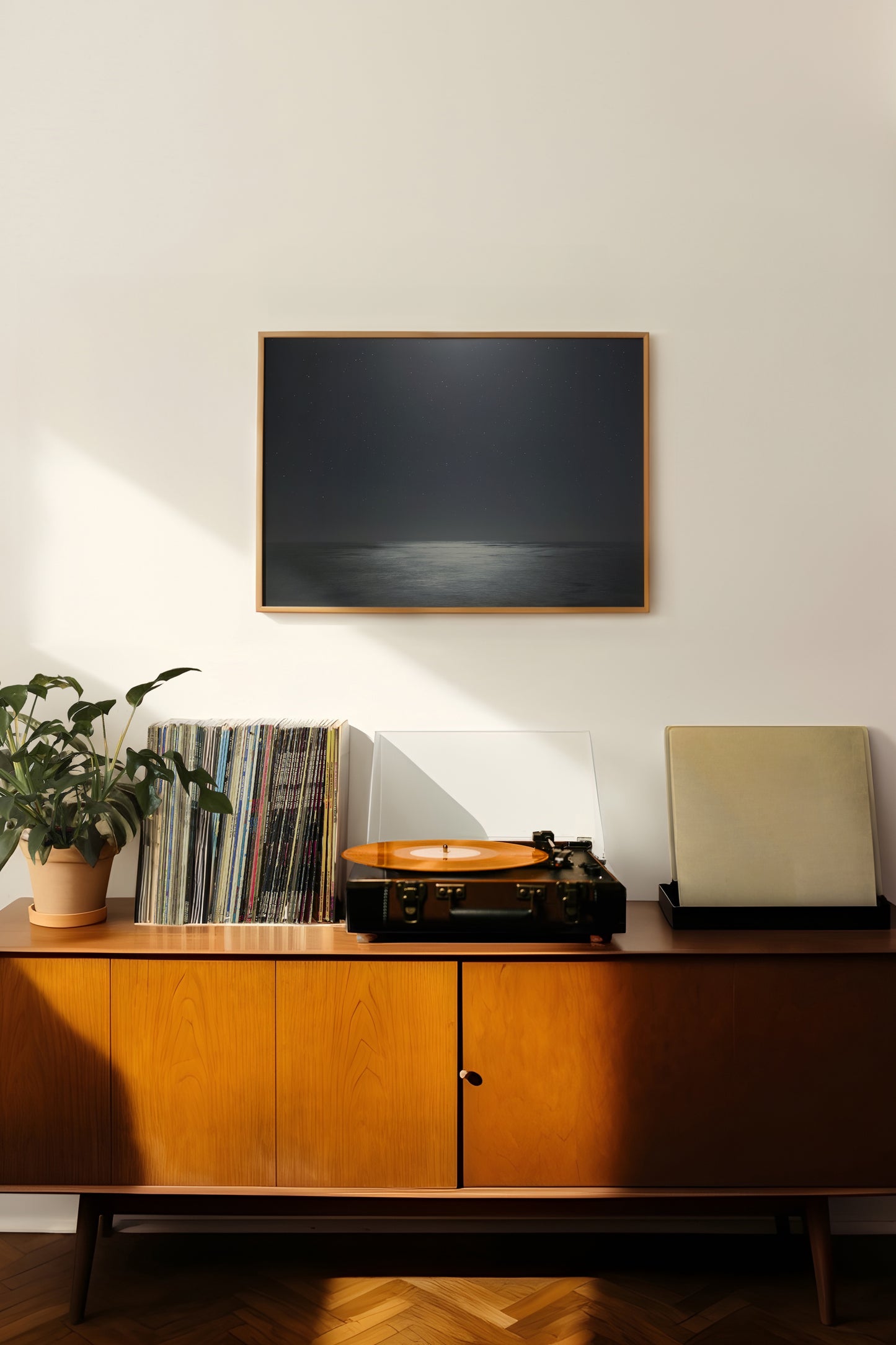 MiDNiGHT serene starry night sky and moonlit sea photograph framed above vintage record player setup.
