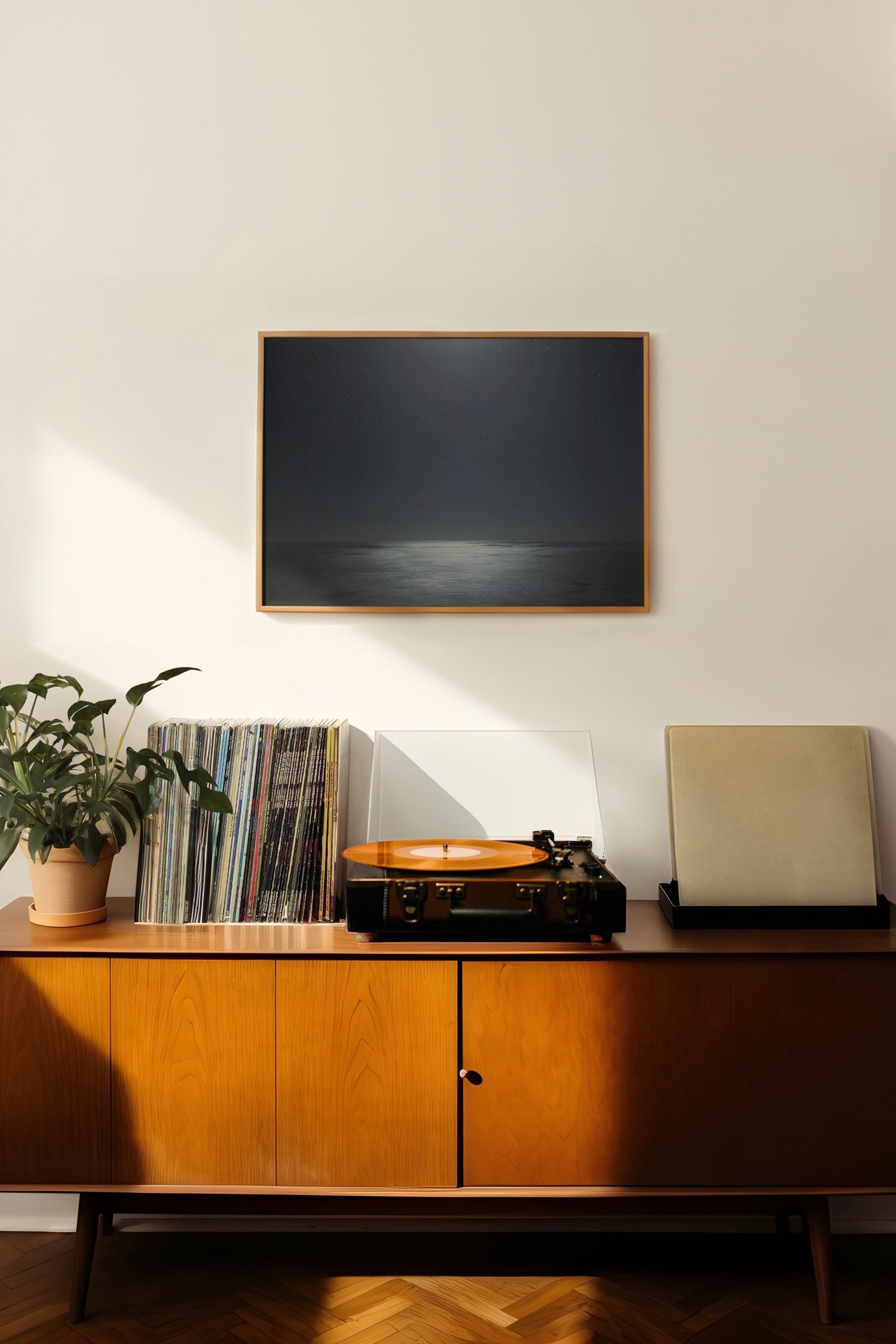 MiDNiGHT serene starry night sky and moonlit sea photograph framed above vintage record player setup.