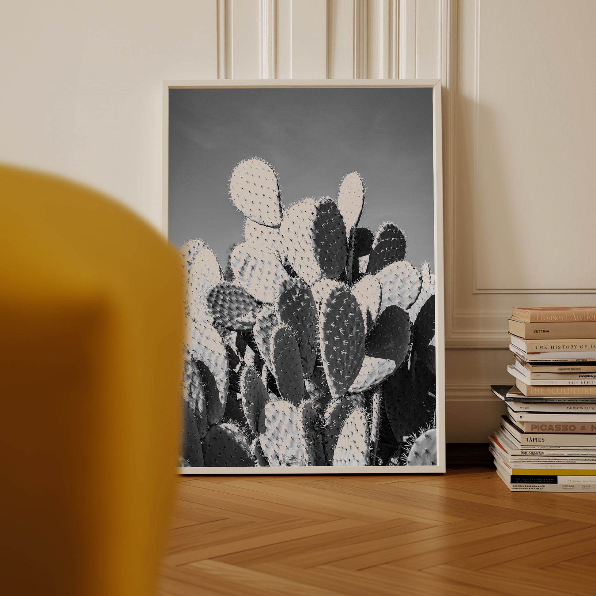 Black and white fine art photograph of a prickly pear cactus cluster under clear desert sky, with dramatic shadows and striking texture.