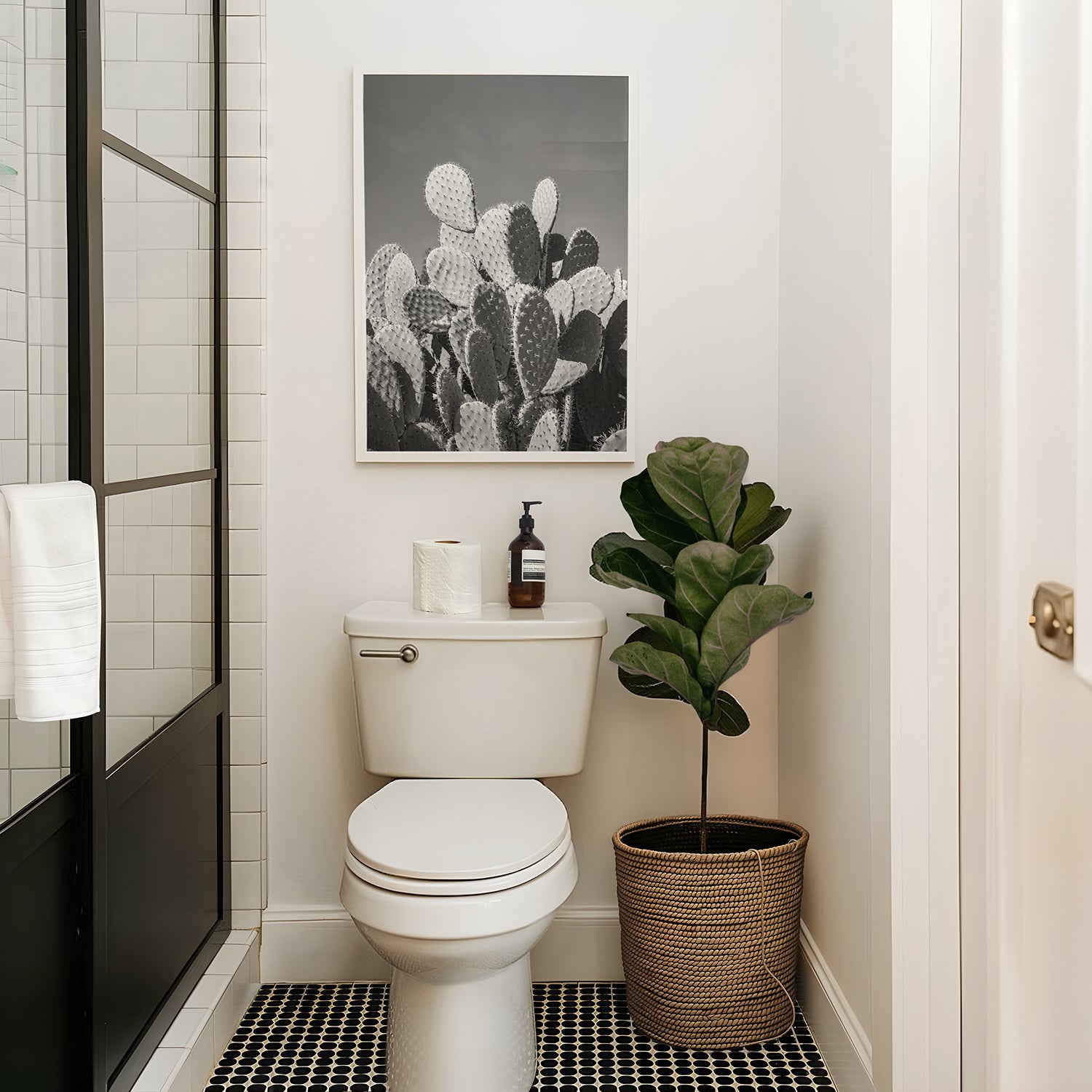 Black and white fine art photograph of a prickly pear cactus cluster under clear desert sky, with dramatic shadows and striking texture.