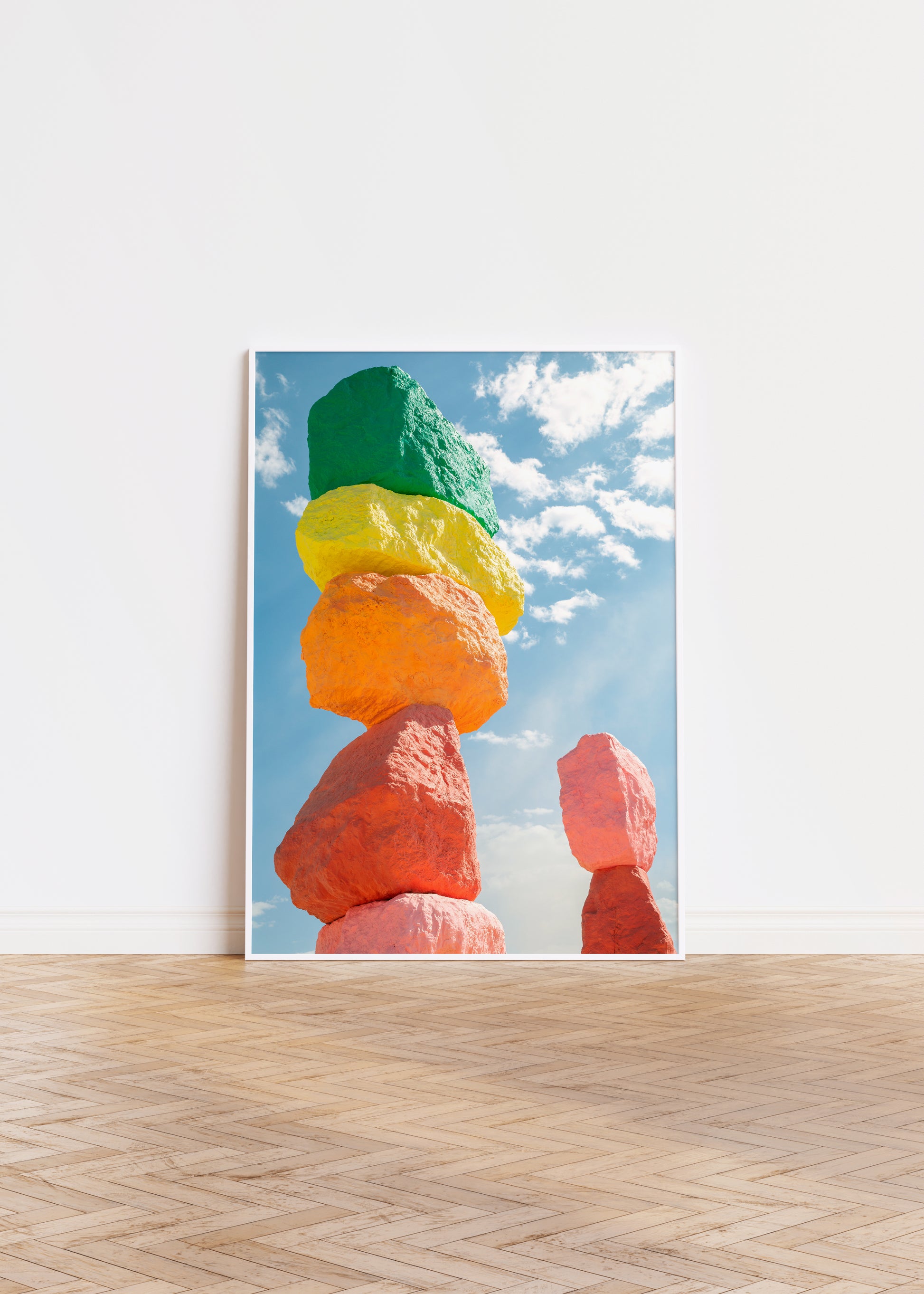 ROCK ON photograph of stacked neon-painted boulders against a bright blue sky with clouds, vibrant and modern.