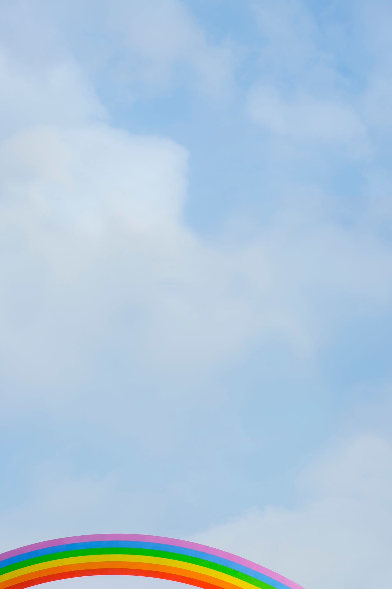 Minimalist sky with soft clouds and a bright rainbow arc, photo titled SOMEWHERE adding joy and whimsy.