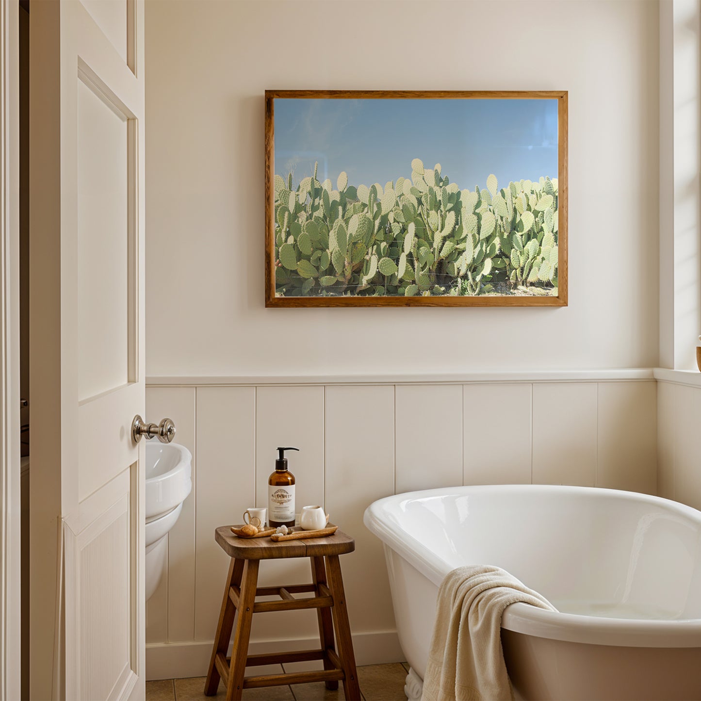 SUGAR SUGAR product showing cactus print above bathtub in a modern, minimalist bathroom with natural light.