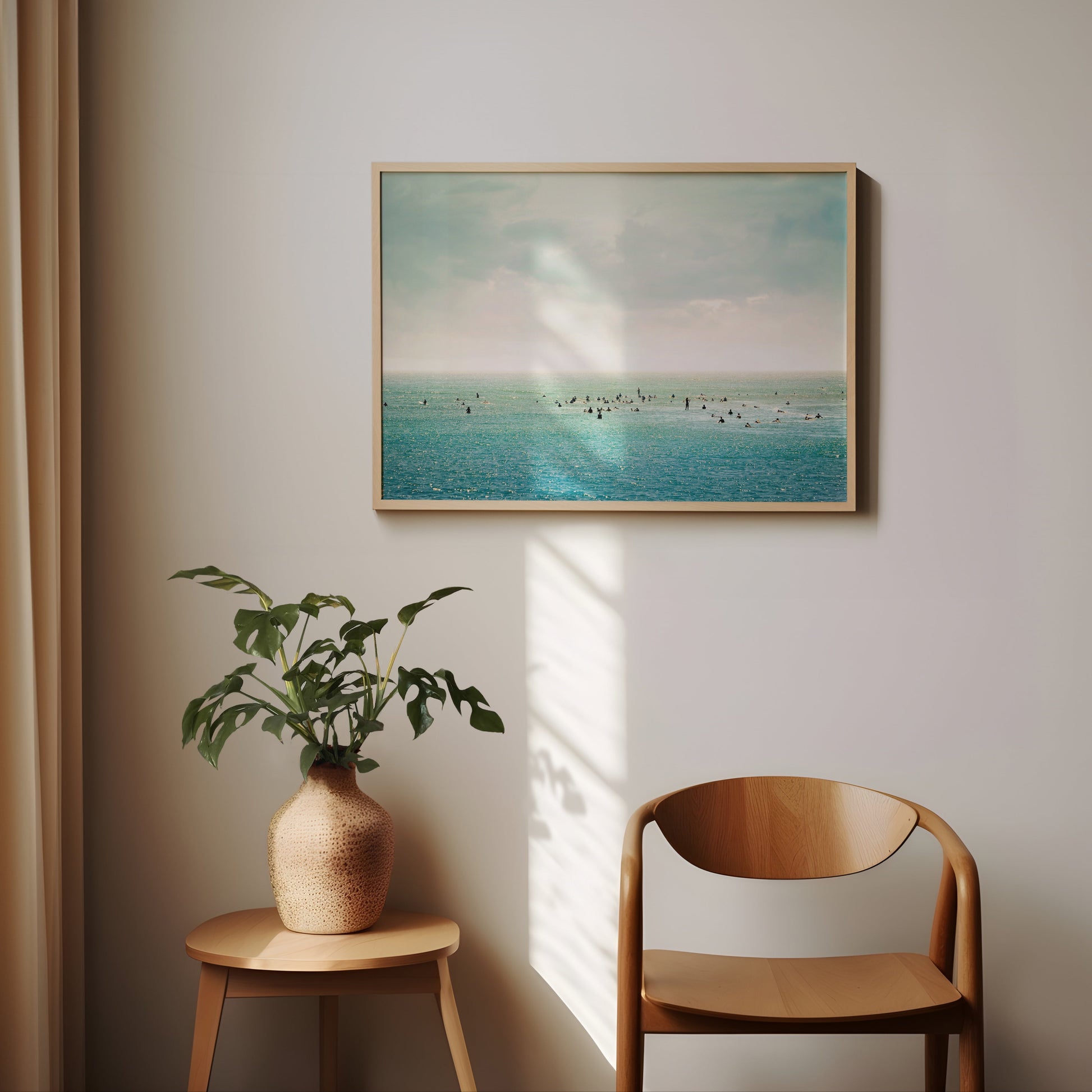 SURFRiDER ocean photo showing surfers waiting for waves under moody skies, perfect for coastal wall decor.