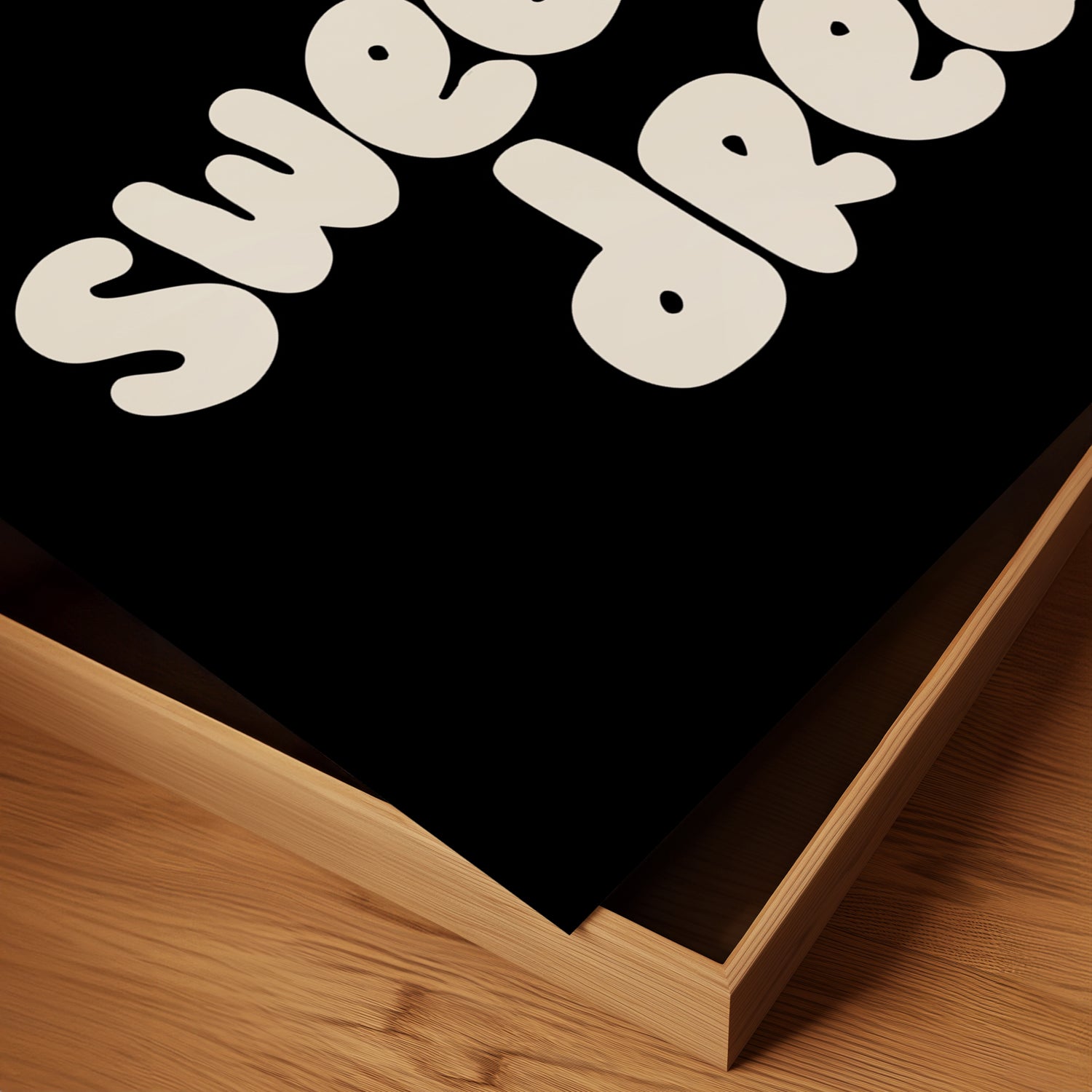 Close-up of the SWEET DREAMS poster with bubbly white text on matte black paper.