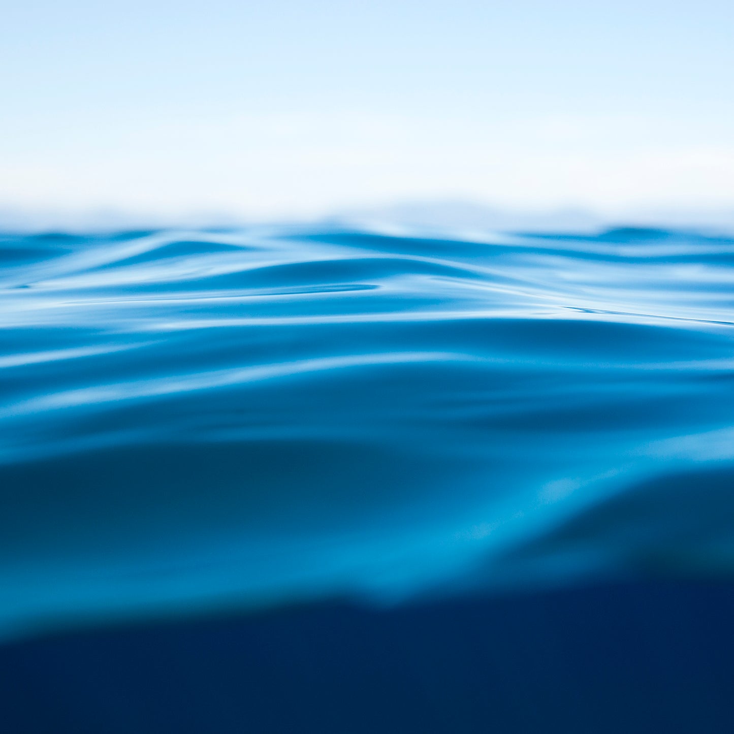 Close-up of calm deep blue water waves representing the serene mood of the TAHOE BLUE art piece.