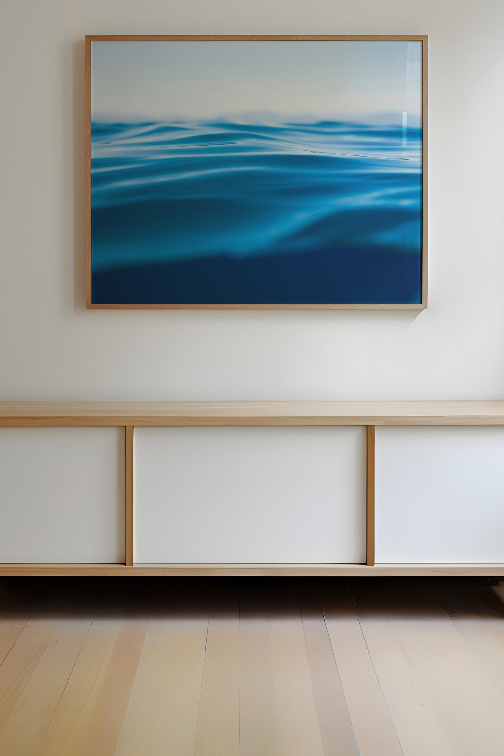 TAHOE BLUE framed wall art featuring minimalist deep blue water waves above modern wooden cabinet.