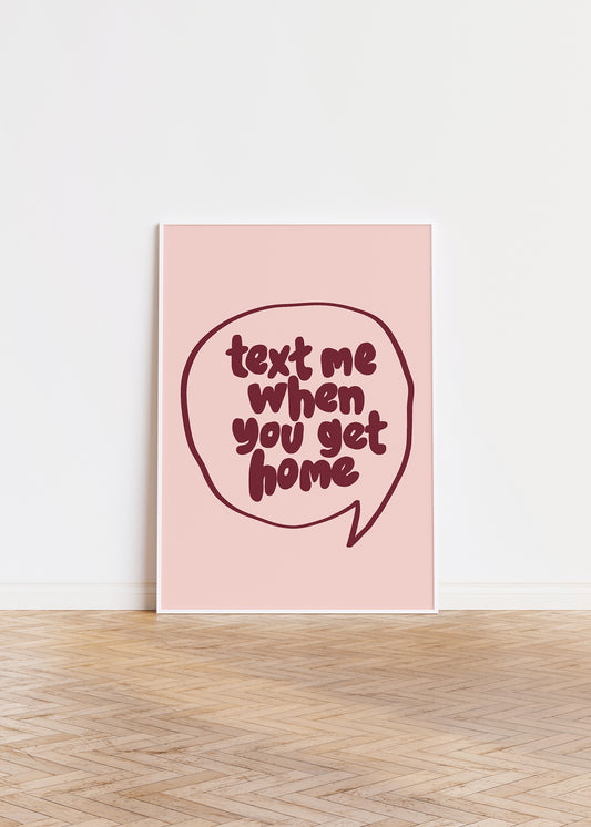 TEXT ME WHEN YOU GET HOME" poster with bold burgundy hand-drawn lettering in a speech bubble on blush background.