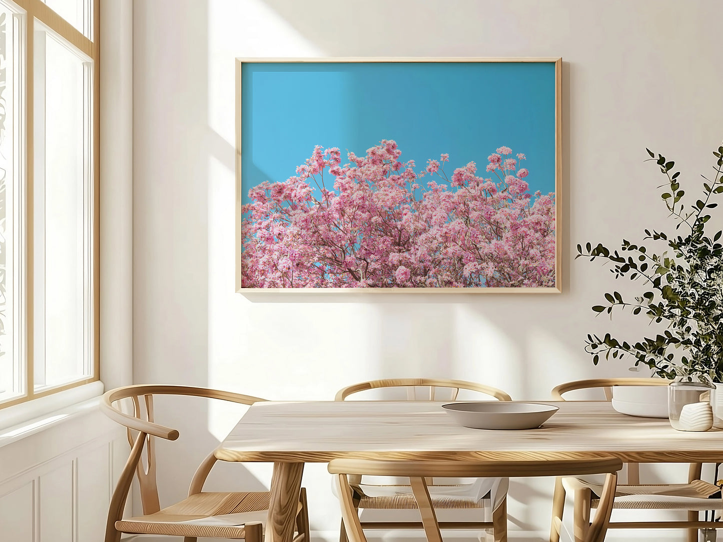 ViLLAGE BLOOM features vibrant pink blossoms against a cyan sky, adding bright natural charm to any room.