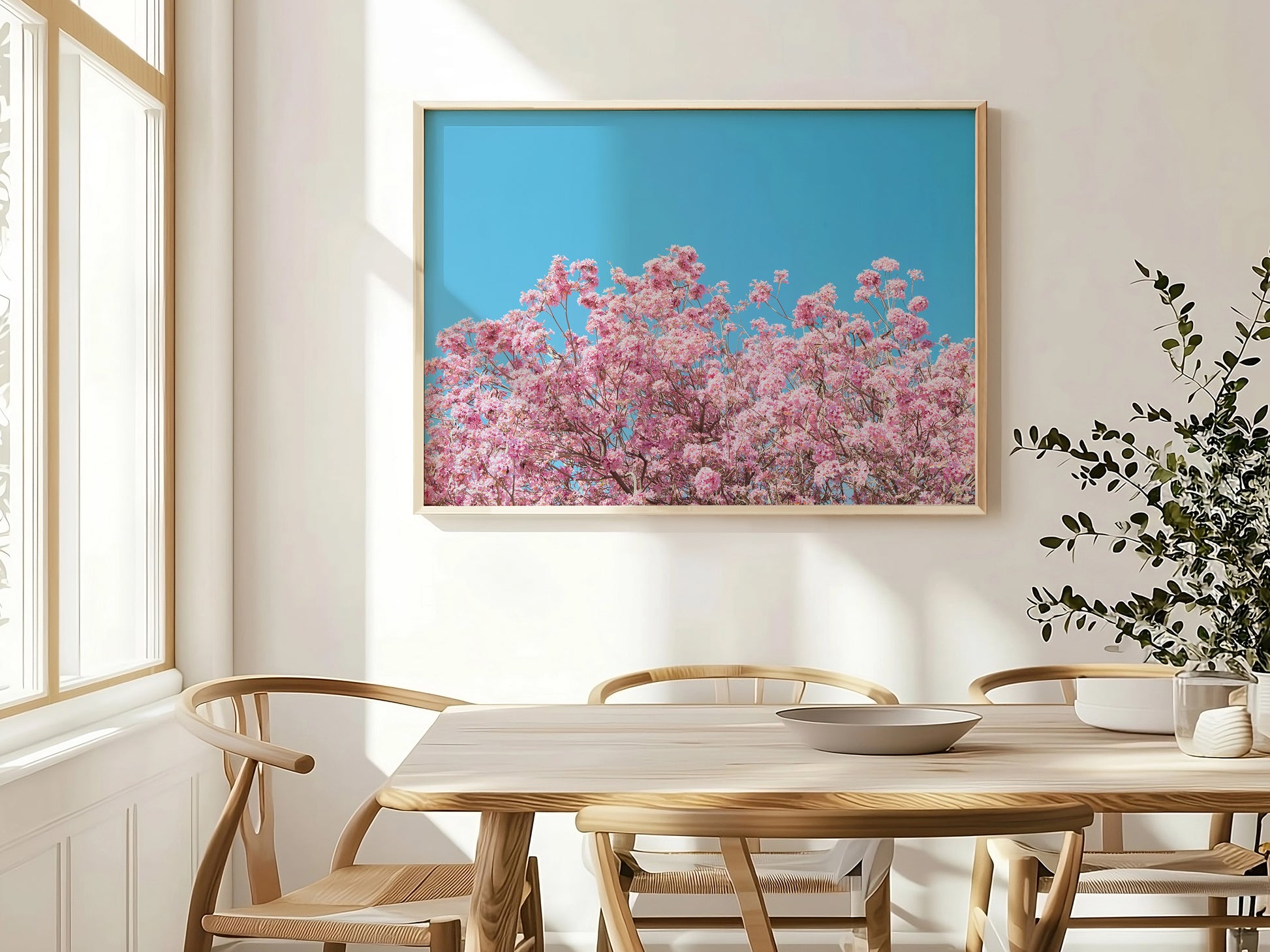 ViLLAGE BLOOM features vibrant pink blossoms against a cyan sky, adding bright natural charm to any room.