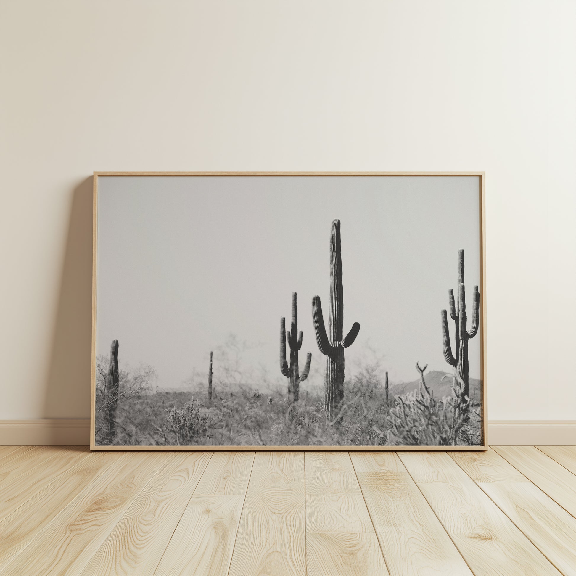 WiLD WiLD black and white saguaro cactus print in minimalistic frame on wooden floor for modern boho decor