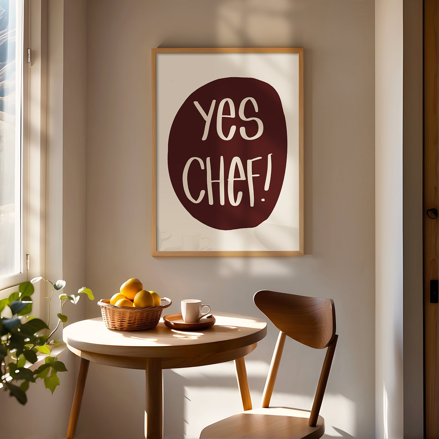 YES CHEF! poster with bold maroon text in a cozy kitchen space with wooden furniture and natural light.