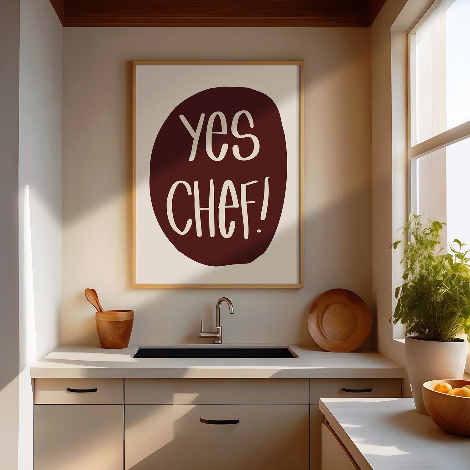 YES CHEF! poster with bold maroon and cream design displayed in a modern kitchen setting above sink.