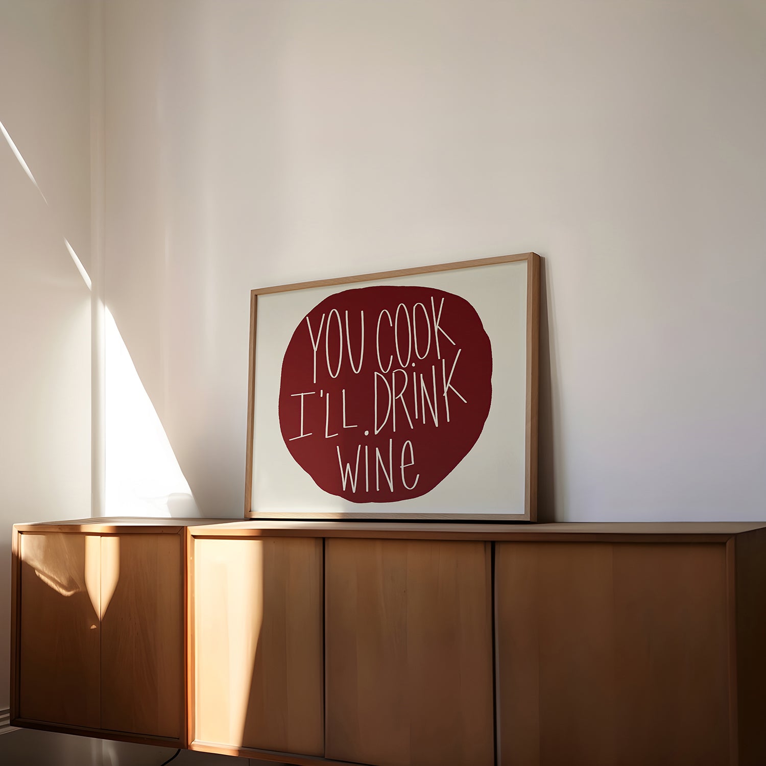 Framed wall art poster "YOU COOK I'LL DRINK WiNE" with burgundy text, perfect for kitchens and dining spaces.