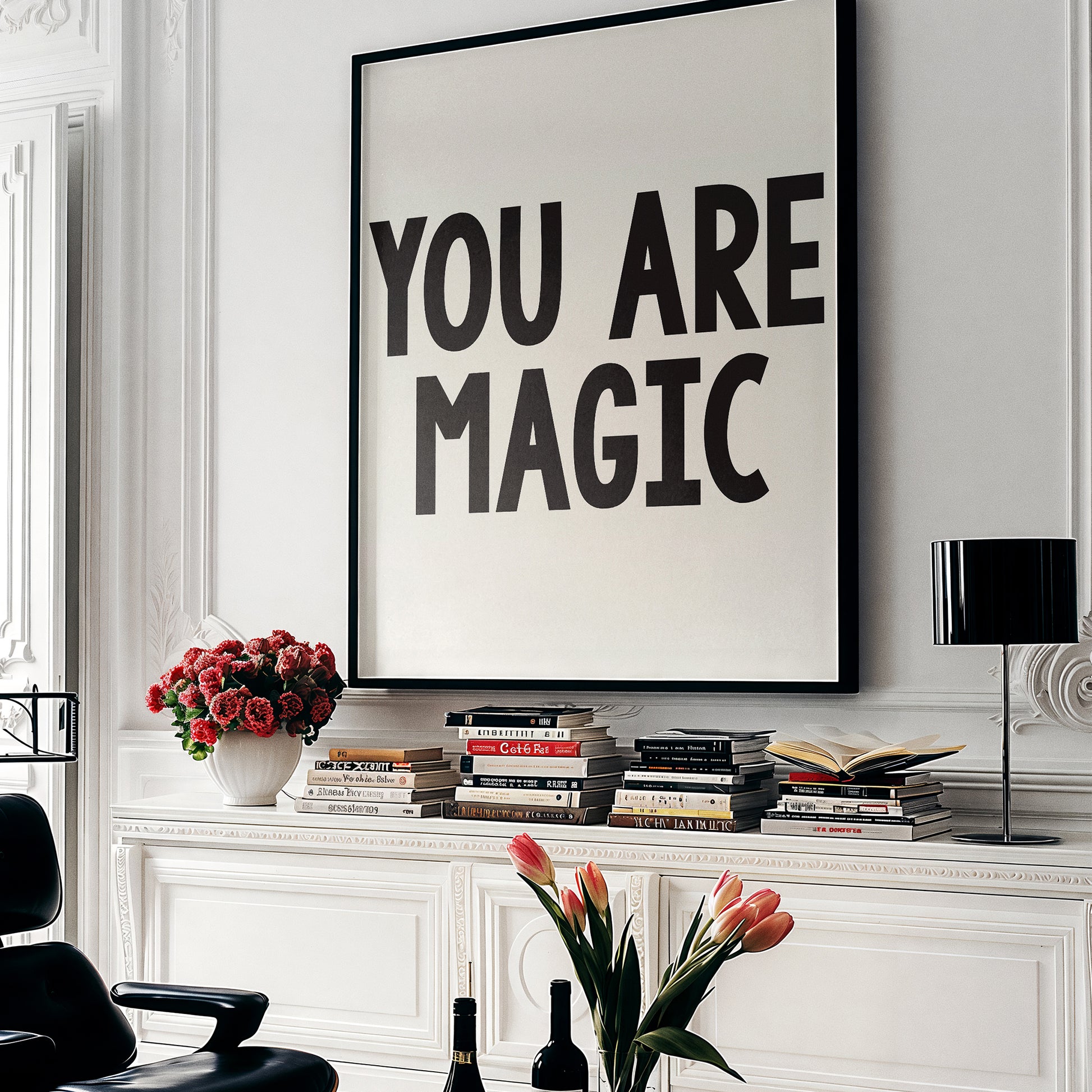 YOU ARE MAGiC poster in bold black text framed on wall above books and flowers in stylish modern room setting