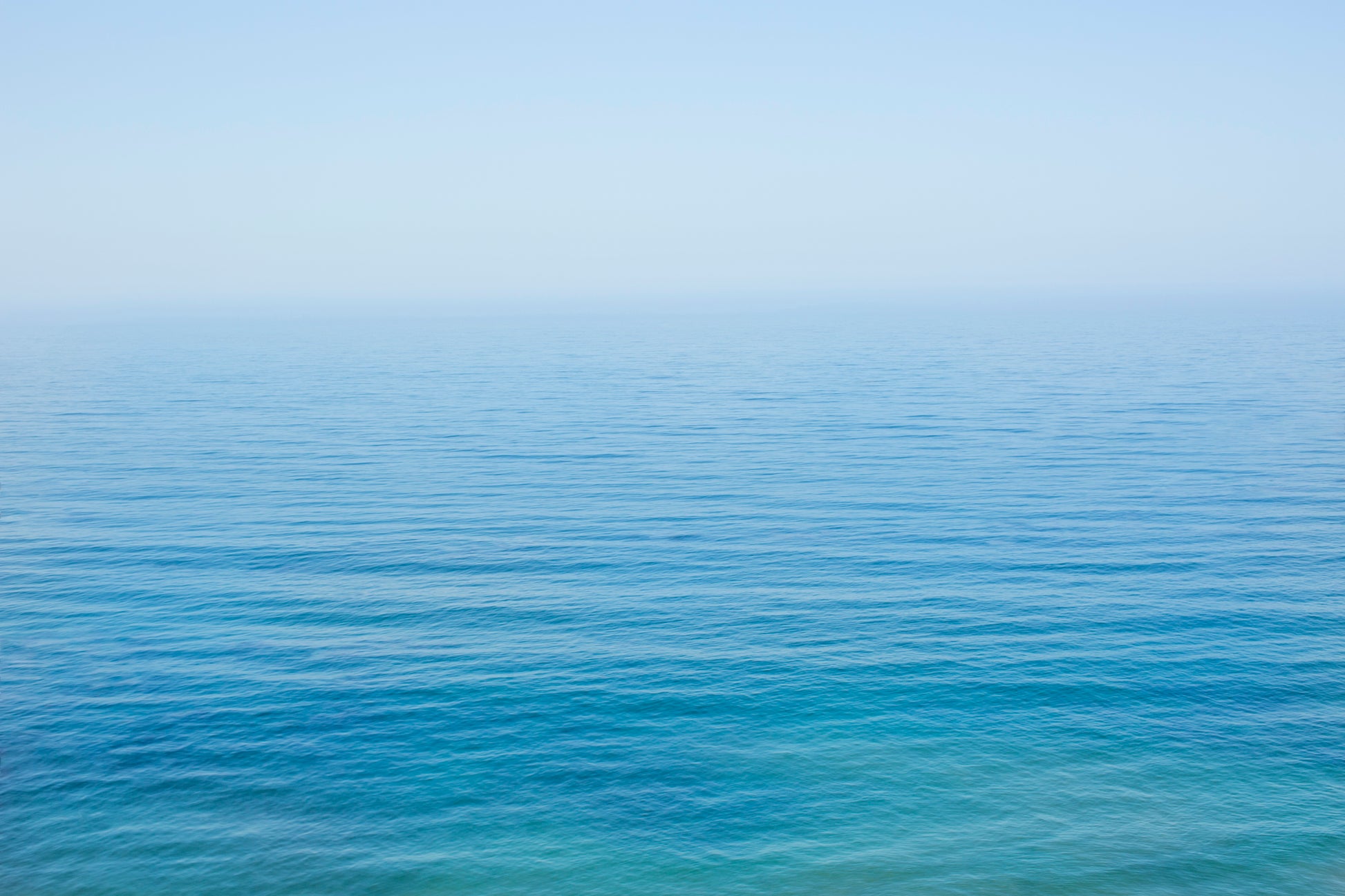 YOU ARE SMALL minimalist ocean print showing calm turquoise and blue sea meeting soft blue sky on the horizon.