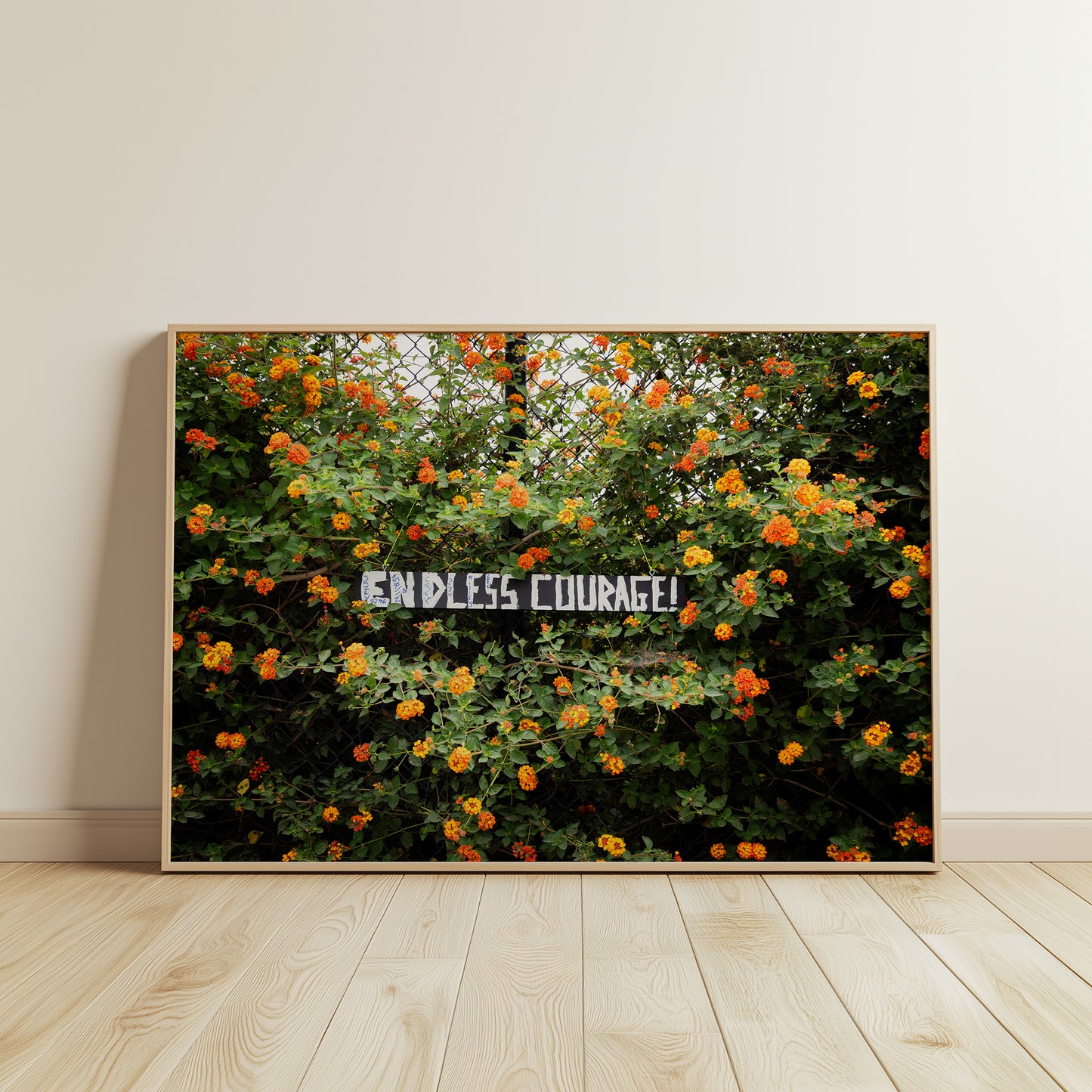 ENDLESS COURAGE art print with vibrant orange and yellow flowers on a chain-link fence in a wooden frame.