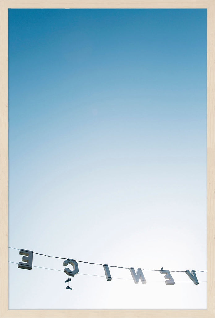 A minimal image from behind the Venice sign looking into the ombre sky and bright sunlight