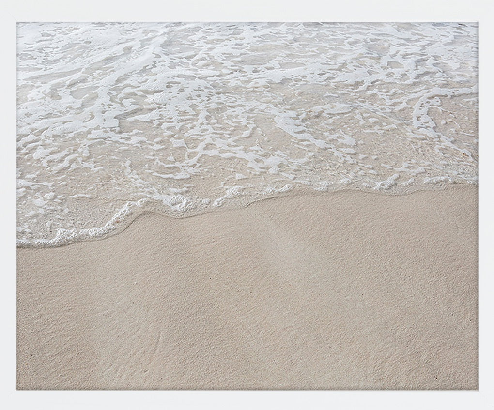 A minimal image of crystal clear water washing upon the sand